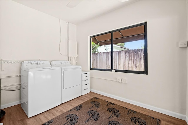 laundry area featuring washing machine and dryer and wood-type flooring