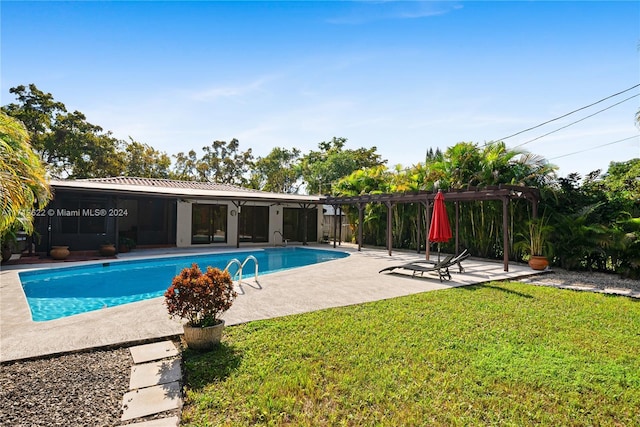 view of swimming pool featuring a lawn, a patio area, and a pergola