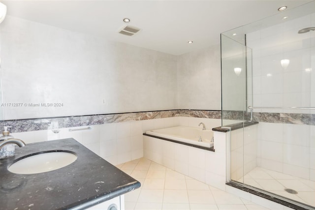 bathroom with vanity, tile patterned flooring, and plus walk in shower