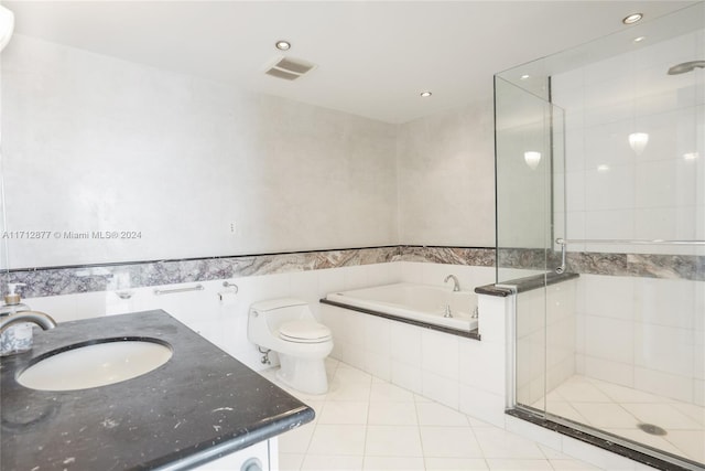 full bathroom featuring separate shower and tub, tile patterned flooring, and tile walls