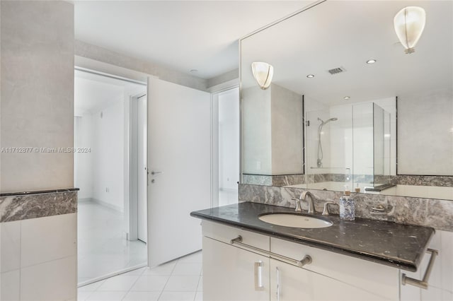 bathroom with vanity, tile patterned floors, and a shower with door