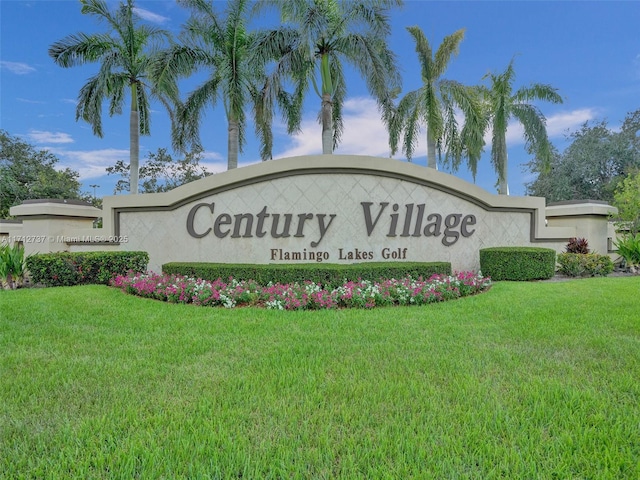 community / neighborhood sign with a yard