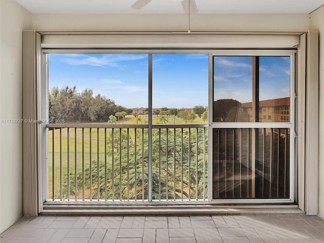 unfurnished sunroom featuring ceiling fan