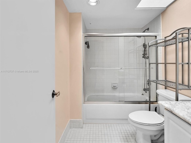 full bathroom with shower / bath combination with glass door, vanity, toilet, and tile patterned flooring