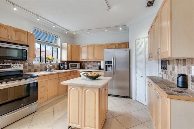 kitchen with a kitchen island, stainless steel appliances, light brown cabinetry, and tasteful backsplash