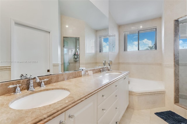 bathroom with separate shower and tub, tile patterned flooring, vanity, and a healthy amount of sunlight