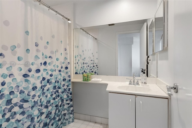 bathroom with tile patterned floors, vanity, and a shower with curtain