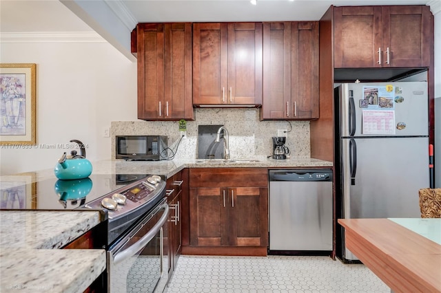 kitchen with light stone countertops, appliances with stainless steel finishes, backsplash, ornamental molding, and sink