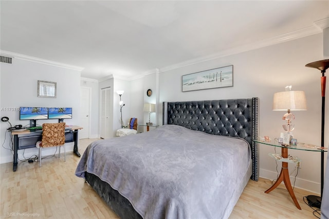 bedroom with light hardwood / wood-style floors and ornamental molding