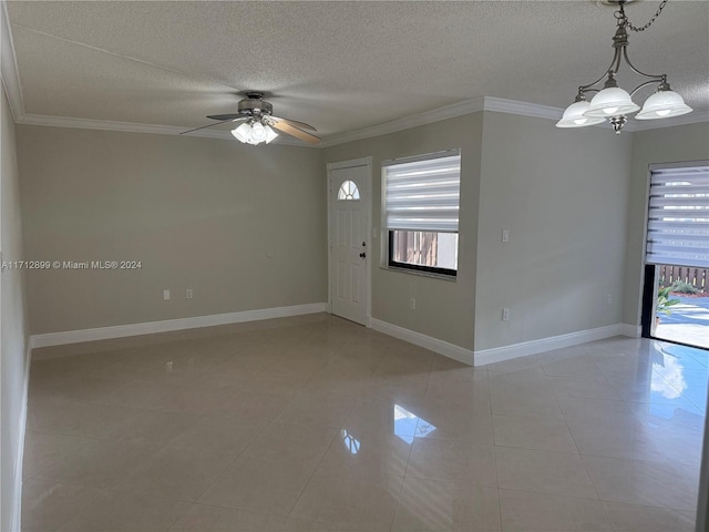 interior space with a textured ceiling, crown molding, and ceiling fan with notable chandelier