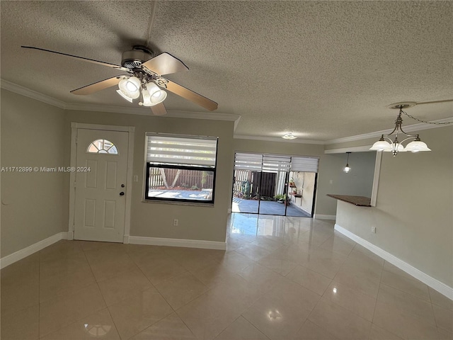 tiled entryway with ceiling fan with notable chandelier, a textured ceiling, and ornamental molding