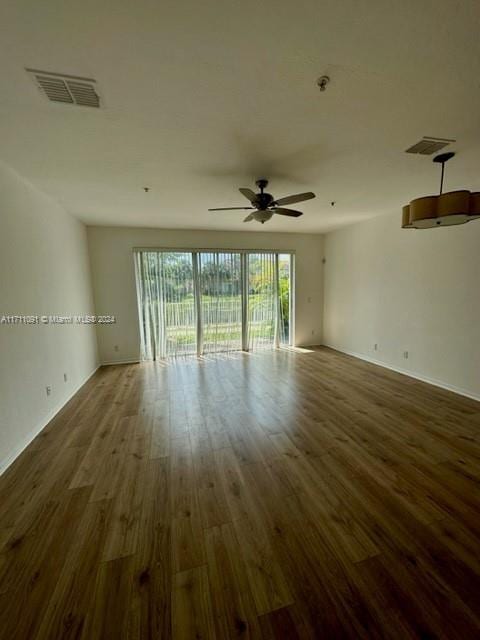 unfurnished room featuring dark hardwood / wood-style floors and ceiling fan