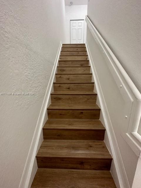 stairway featuring wood-type flooring