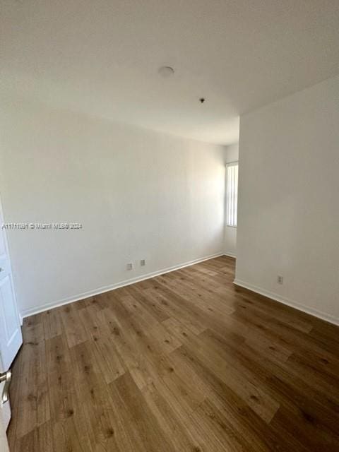 spare room with hardwood / wood-style flooring