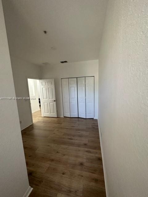 corridor featuring dark hardwood / wood-style floors