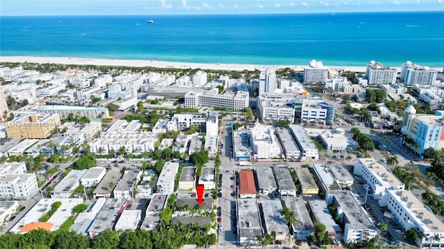 birds eye view of property with a beach view and a water view