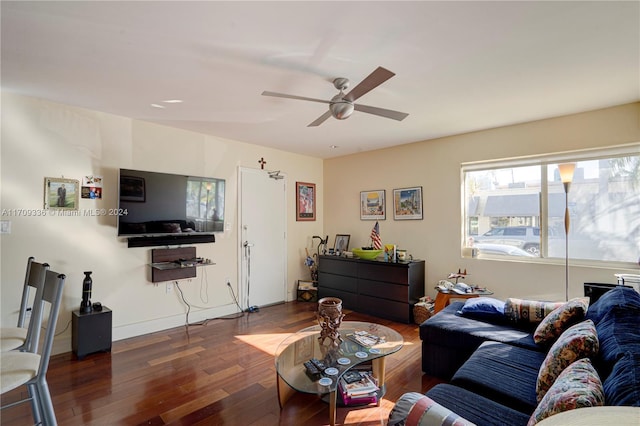 living room featuring ceiling fan and dark wood-type flooring