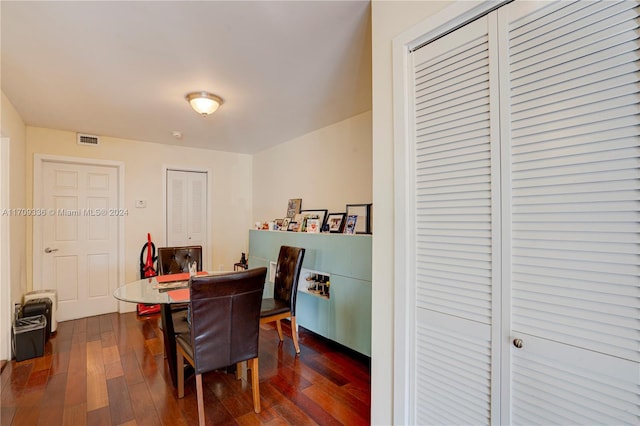 dining space featuring dark wood-type flooring