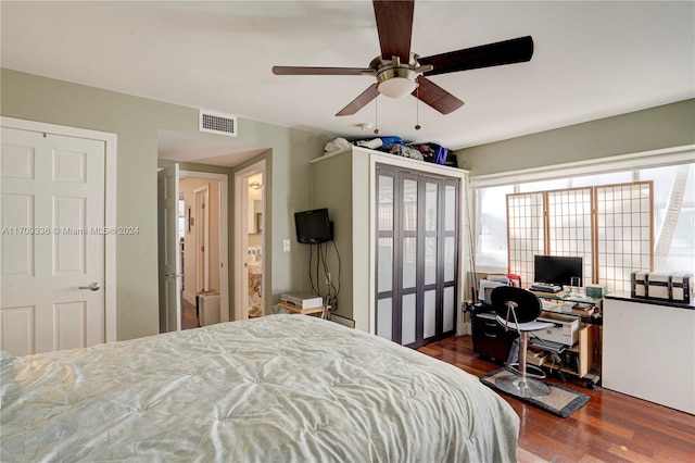 bedroom with dark hardwood / wood-style floors and ceiling fan