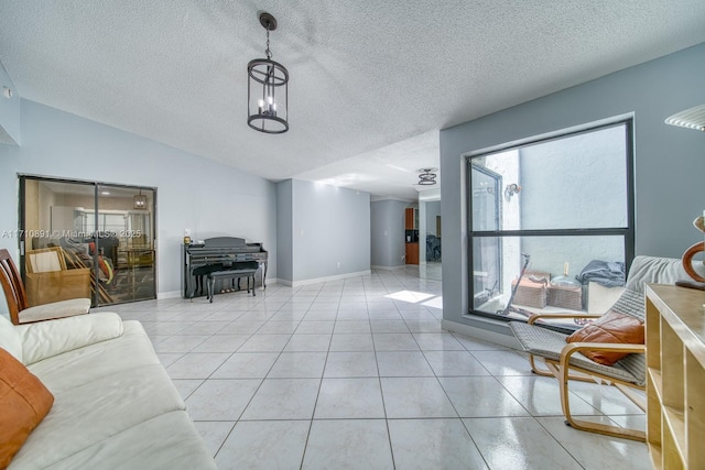 living room featuring lofted ceiling, a chandelier, a textured ceiling, and light tile patterned floors