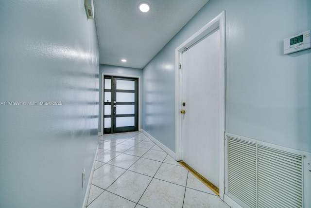 doorway featuring light tile patterned flooring