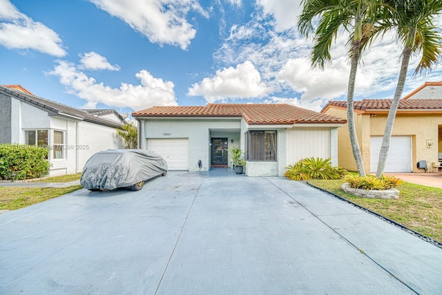 mediterranean / spanish home featuring a garage