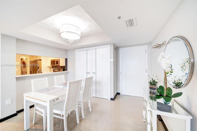 dining room with a tray ceiling