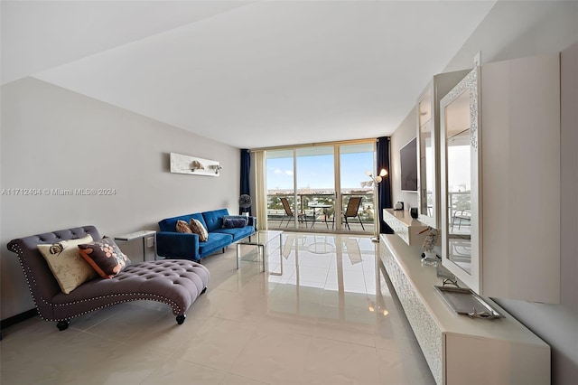 tiled living room featuring floor to ceiling windows