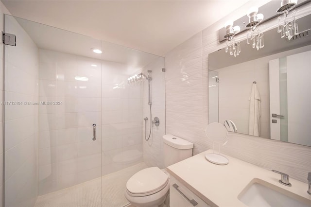 bathroom featuring vanity, toilet, an enclosed shower, and tile walls