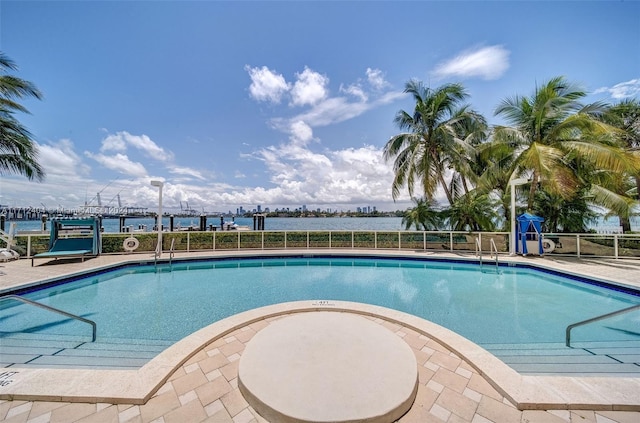 view of swimming pool featuring a water view