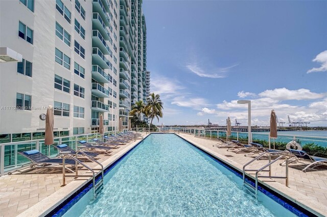 view of swimming pool with a water view