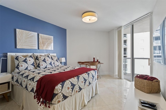 bedroom featuring multiple windows and a wall of windows