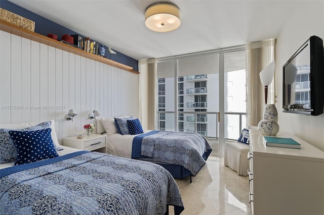 bedroom featuring a wall of windows