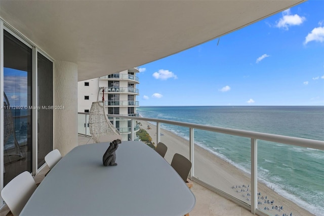 balcony featuring a water view and a view of the beach