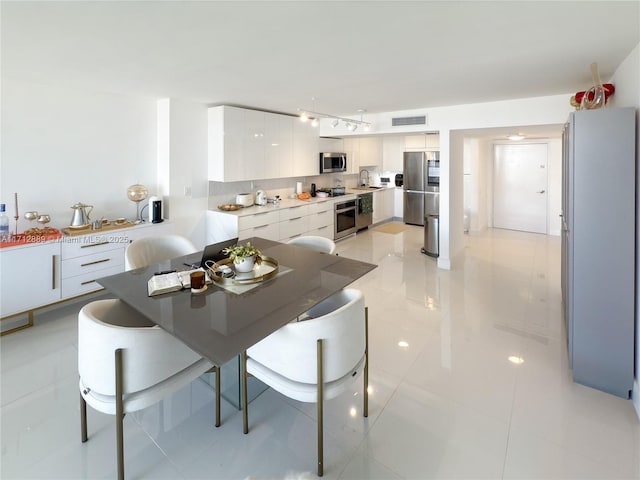 dining area with light tile patterned flooring and visible vents