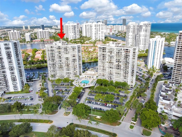 birds eye view of property featuring a view of city and a water view