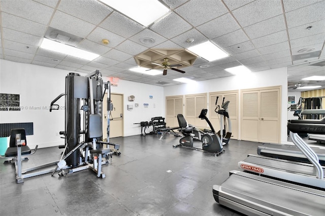 workout area with a paneled ceiling and ceiling fan