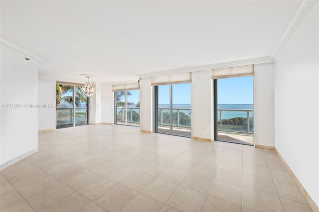 tiled empty room with a water view, crown molding, floor to ceiling windows, and a notable chandelier