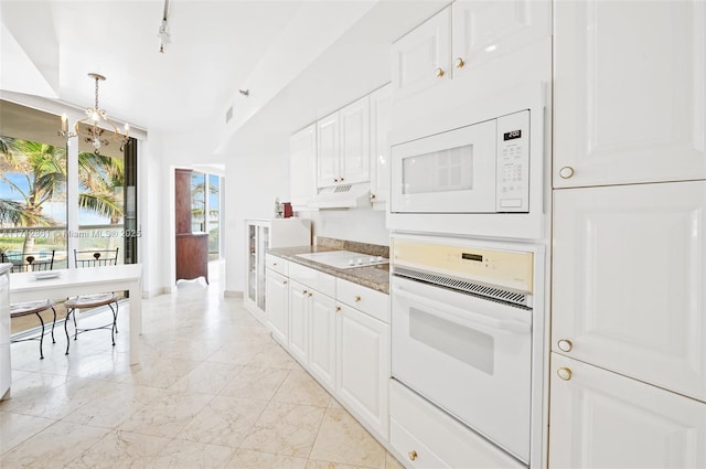 kitchen with light stone countertops, a chandelier, white appliances, white cabinets, and custom exhaust hood