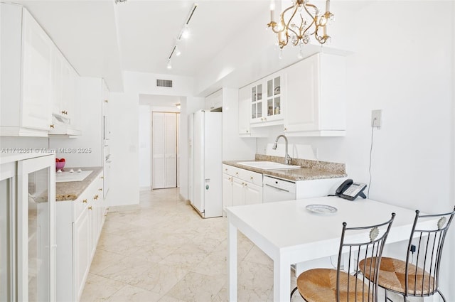 kitchen with white appliances, white cabinets, sink, decorative light fixtures, and a chandelier