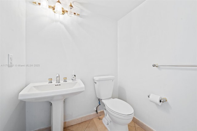 bathroom with tile patterned floors and toilet