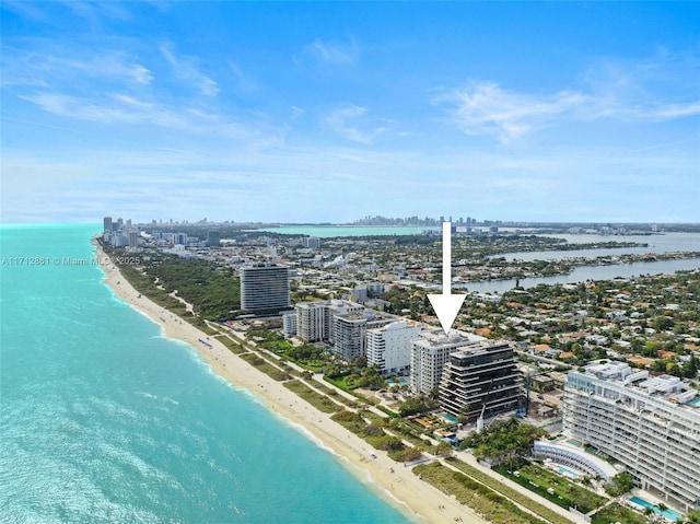 birds eye view of property featuring a view of the beach and a water view