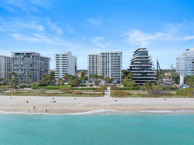 bird's eye view with a water view and a beach view