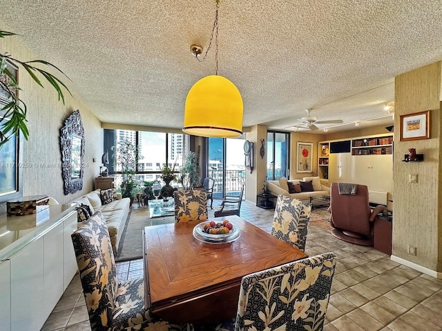 dining area featuring light tile patterned floors, a textured ceiling, and ceiling fan