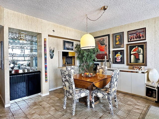 dining space featuring a textured ceiling