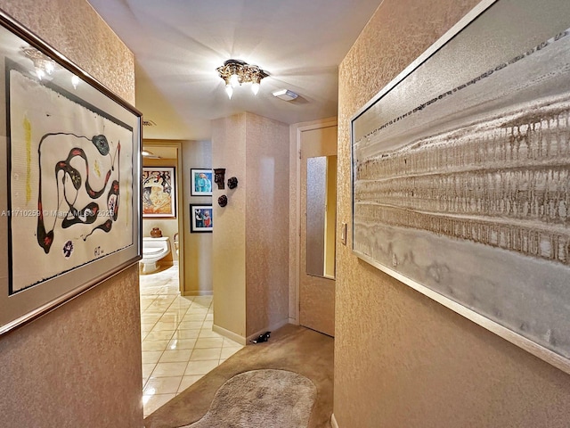 520 Brickell Key Dr Unit A1802, Miami, FL 33131 - corridor featuring a textured wall and tile patterned flooring
