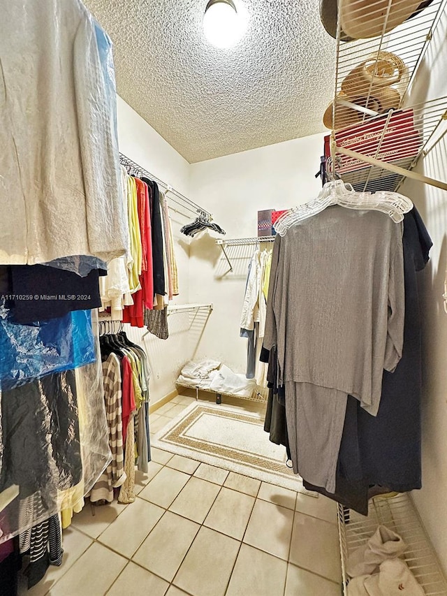 spacious closet featuring tile patterned flooring