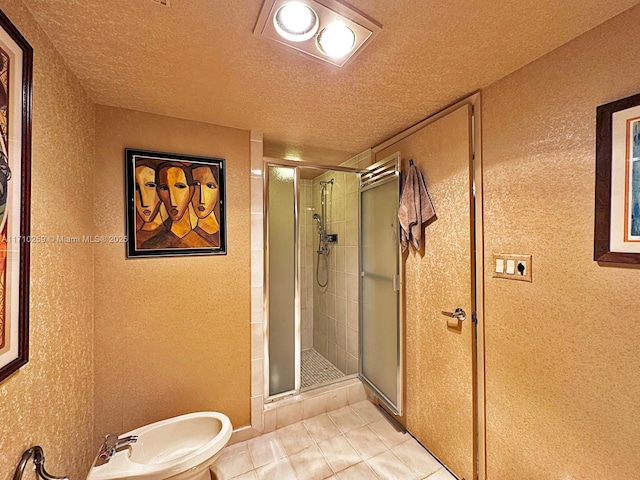 520 Brickell Key Dr Unit A1802, Miami, FL 33131 - full bathroom with a textured wall, a stall shower, tile patterned flooring, a textured ceiling, and a bidet
