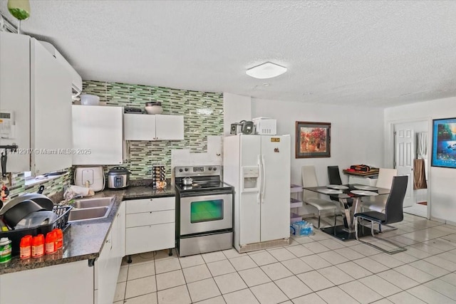 kitchen featuring tasteful backsplash, stainless steel range with electric stovetop, sink, white cabinets, and white fridge with ice dispenser