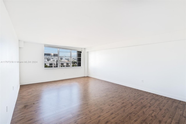 unfurnished room featuring dark hardwood / wood-style flooring